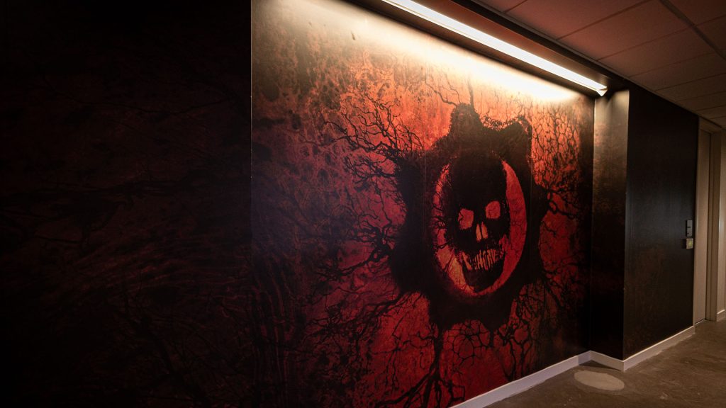 A giant print of the rift Omen decorating the wall of the studio