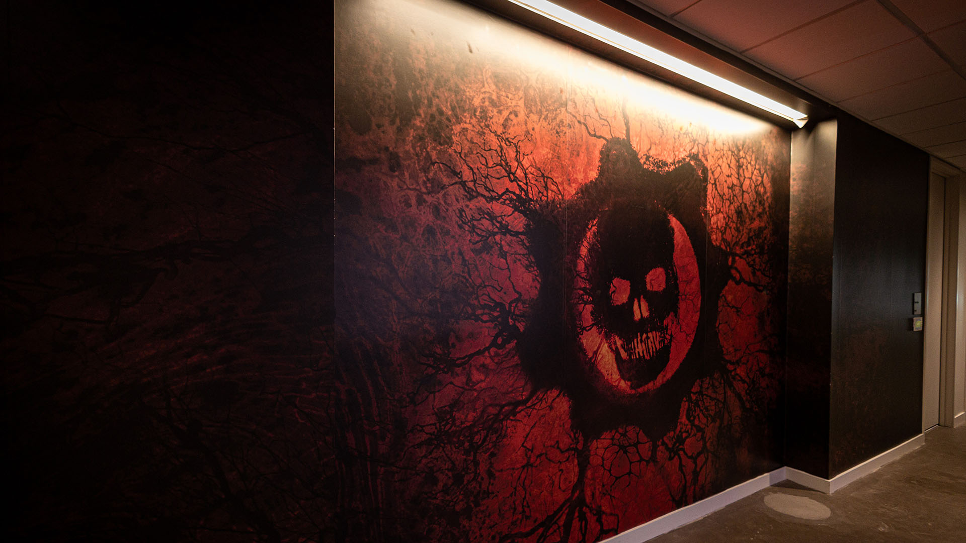 A giant print of the rift Omen decorating the wall of the studio