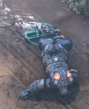 A downed boomer on the battlefield. there is a weapon beside him that can be picked up by another character