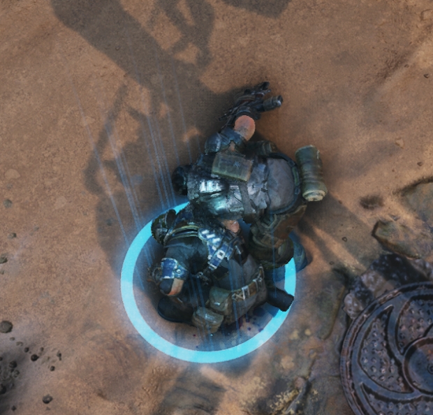 A player character reviving a teammate who is nearing death